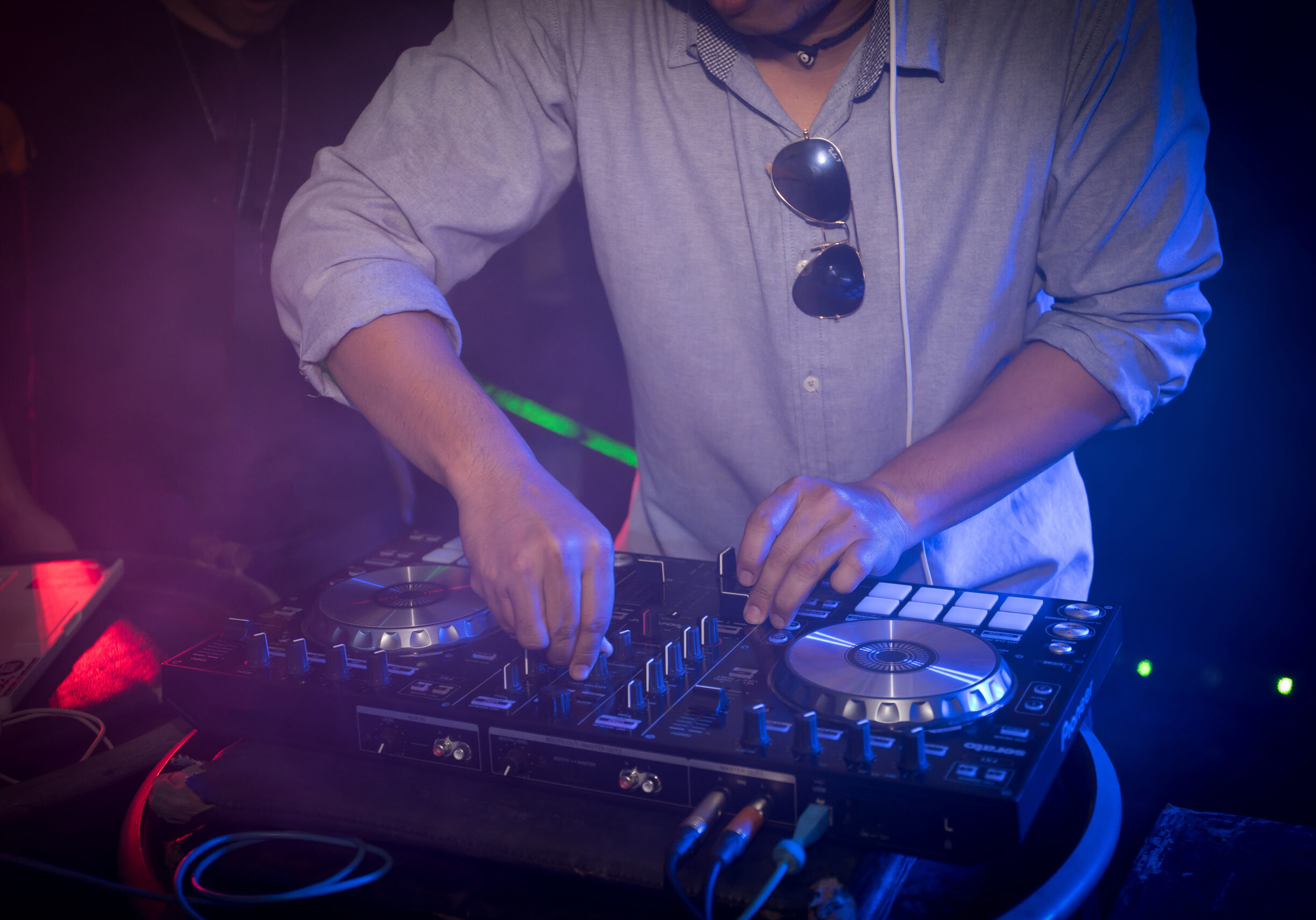 DJ playing turntable music on night club party