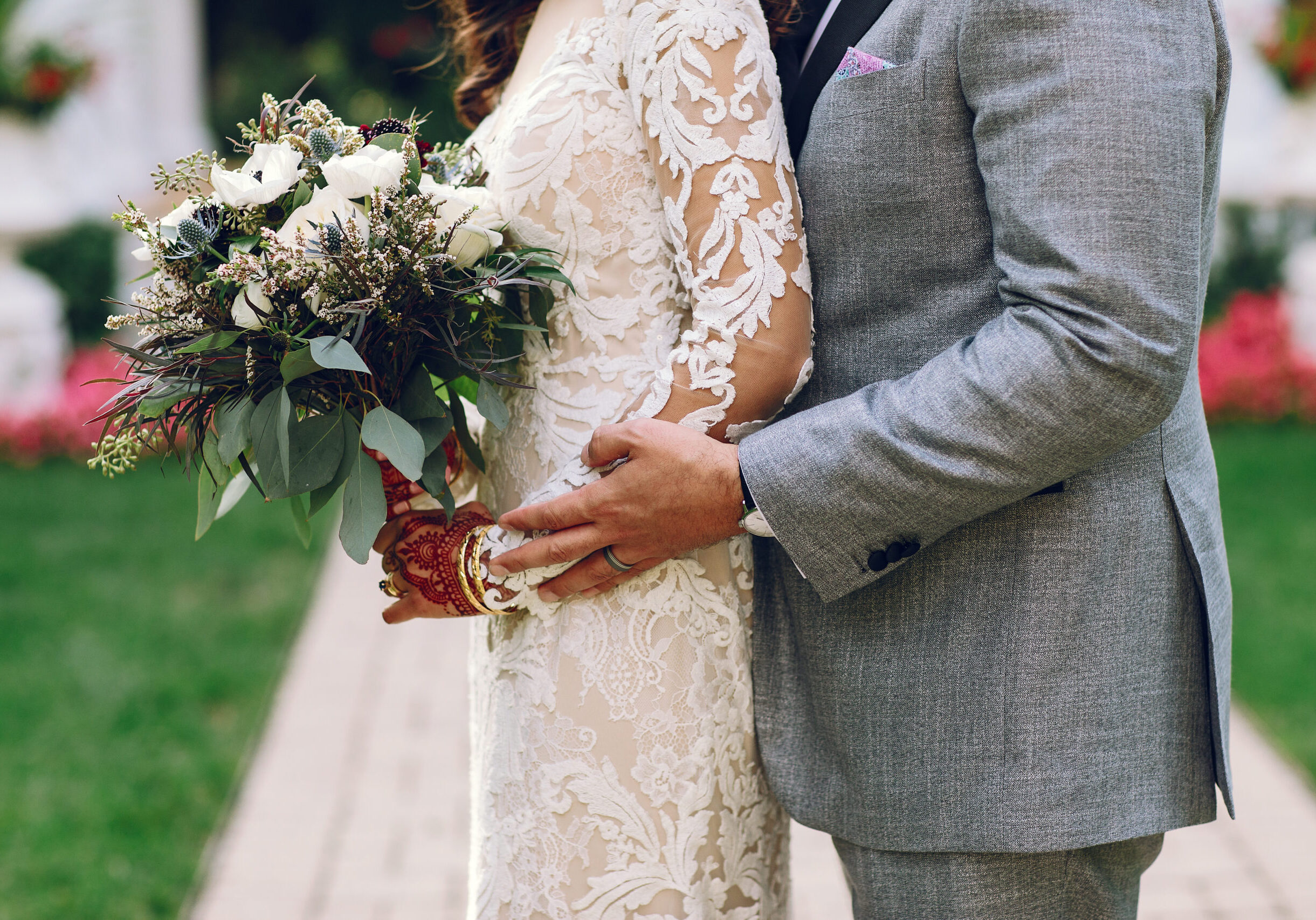 Beautiful bride. Handsome fiance in a gray suit. Couple in a park